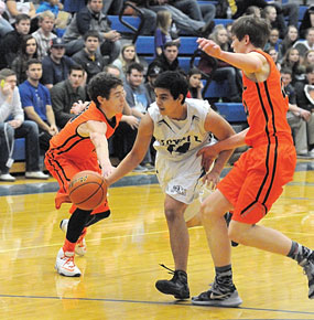 Lovell senior guard Konner Davis splits a pair of Powell defenders during Lovell’s 50-31 win in the Big Horn Basin Basketball Classic at Winterholler Gym Saturday afternoon. David Peck photo
