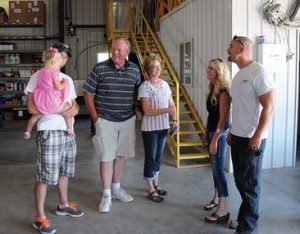 Hundreds turned out for the Bairco open house Friday at their new building on East Cannery Road. Owners Devin and Stacy Bair, right, chat with Dean and Teddie Tippetts (center) and Michael Hendershot 
