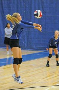 Lovell High School senior Samantha Newman bumps the ball to a setter during a volleyball match at the North Big Horn County Tournament Saturday in Lovell as junior Kendre Kidgell looks on. David Peck photo 