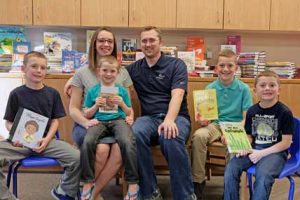 The Mason family (l-r) Jack, Kristen, Rhett (on mom’s lap), Reid, Clark and Connor hosted a book drive to honor the short life of their loved one, Sara Kate, who died of a rare heart defect only five days after her birth. Patti Carpenter photo