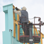 An employee of Epcon Sign Group installs LED lighting on the Hyart Theatre sign last week. The iconic sign will soon light up the night on Lovell’s Main Street once again. David Peck