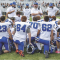 Lovell coaches (l-r) Bill Scheckler, Michael Jameson (behind), Nicc Crosby, Greg Rael, Logan Blau and Bob Weber speak to the team at halftime against Buffalo on Saturday. Bulletin photo by Joseph Ciembroniewicz