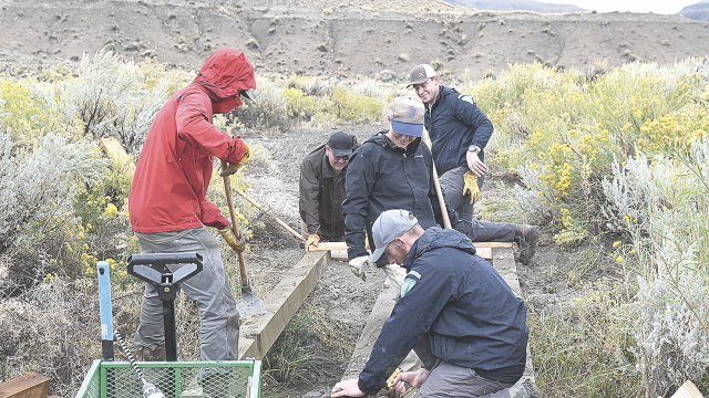 BLM employees work on making an ADA accessible trail on Public Lands Day Saturday at Rainbow Canyon Interpretive Site. Pictured are (l-r) Anthony Camiccia, Abel Guevara, Camille Scott, Zach Cowfer with Rick Tryder in the foreground. Sherry Snell