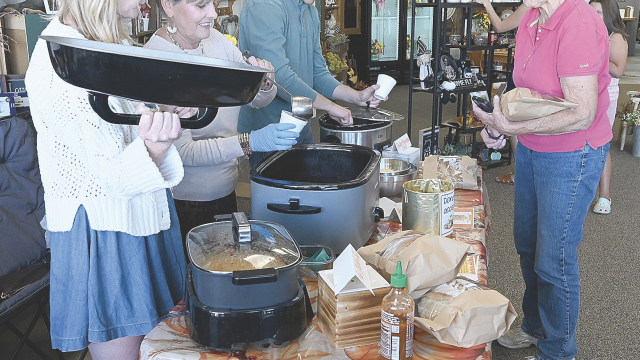 Haley Sorenson (left), her mom, Lea, and husband Cameron Miller serve soup to Jane Undem at Valley Flower and Gifts during the Fall Festival soup walk Saturday in Lovell. The soup fundraiser raised around $2,000 for the Lovell Library. David Peck