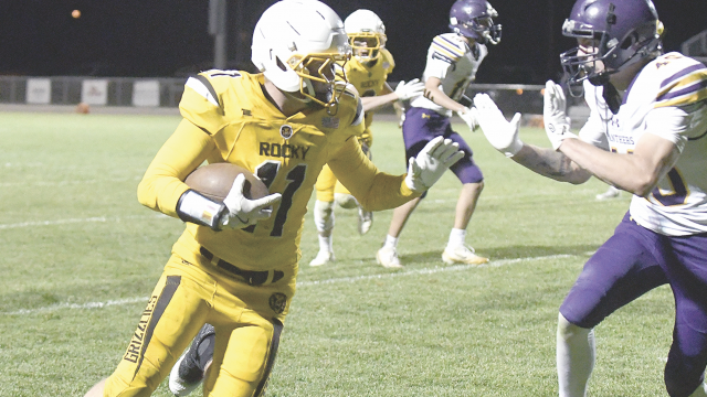 Rocky Mountain junior Ryan Grant puts a move on a Saratoga defender after receiving a pass from Mason Moss during Rocky’s 18-8 win over the Panthers Friday night. David Peck